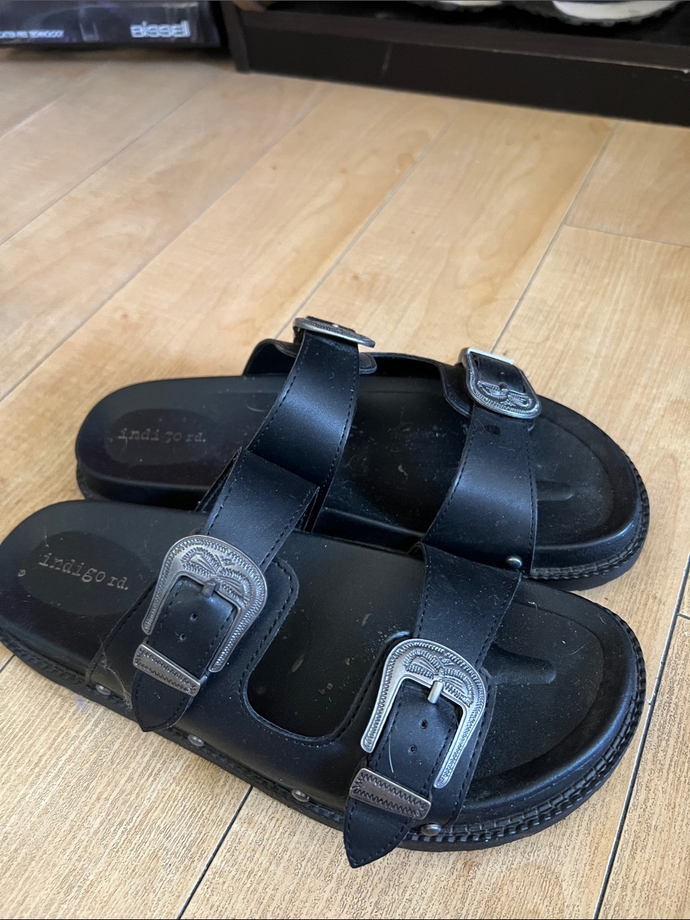 Black sandals with silver buckle detailing